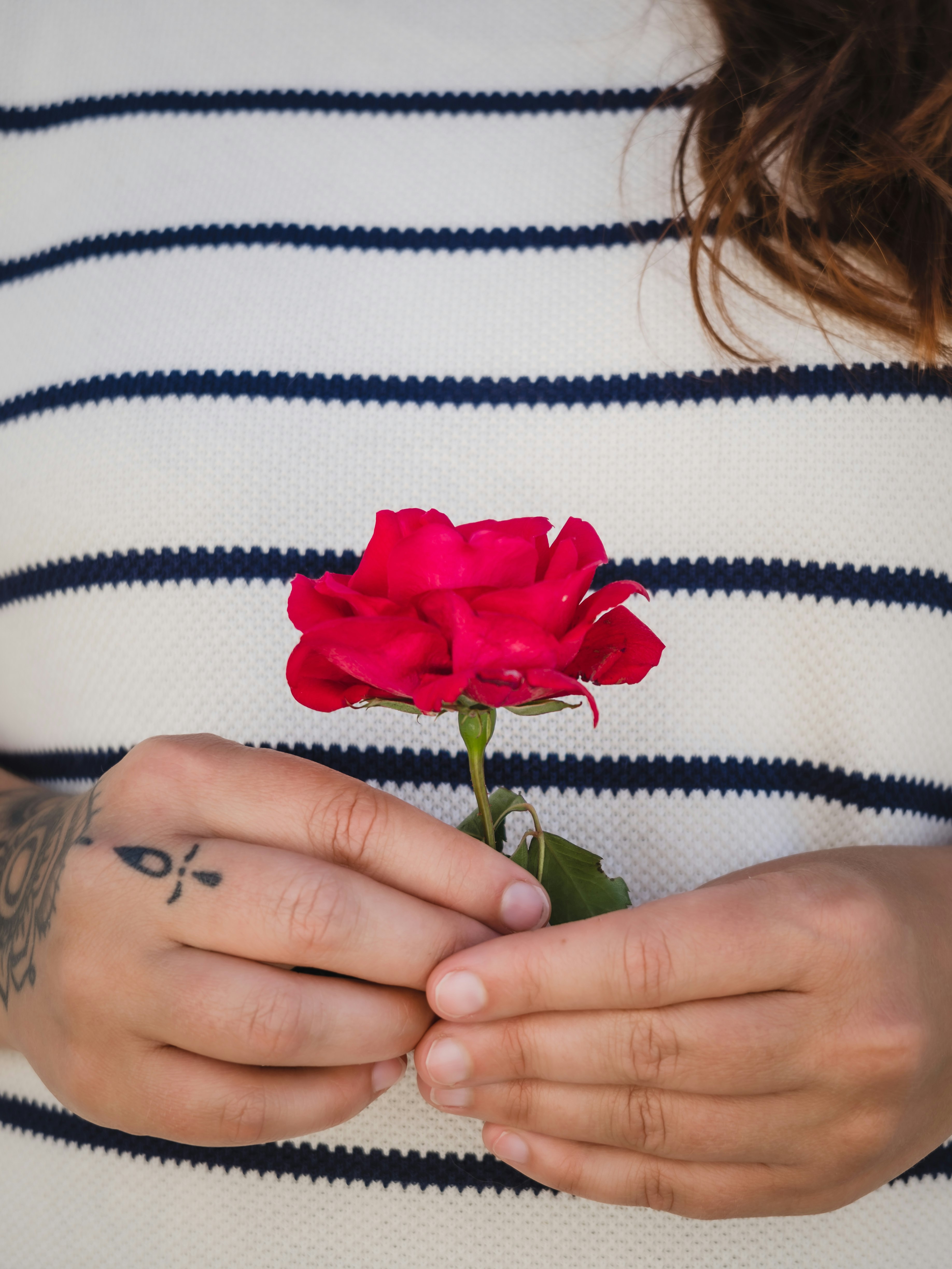 woman holding red rose flower